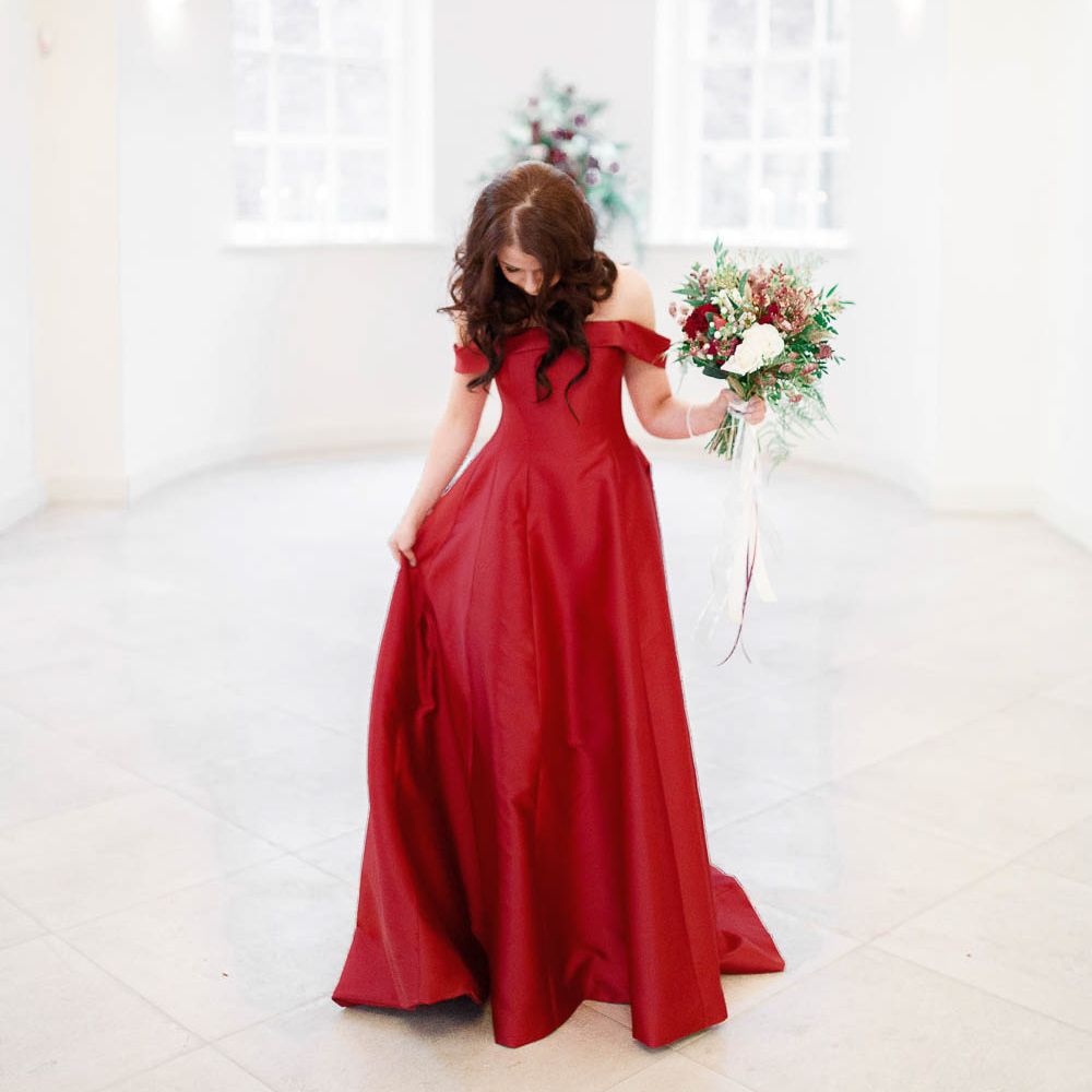 Bride in Bespoke Red Gown from agape Bridal Boutique | Red New Years Eve Winter Wedding at Iscoyd Park, Shropshire | White Stag Wedding Photography | Lovetwofilm