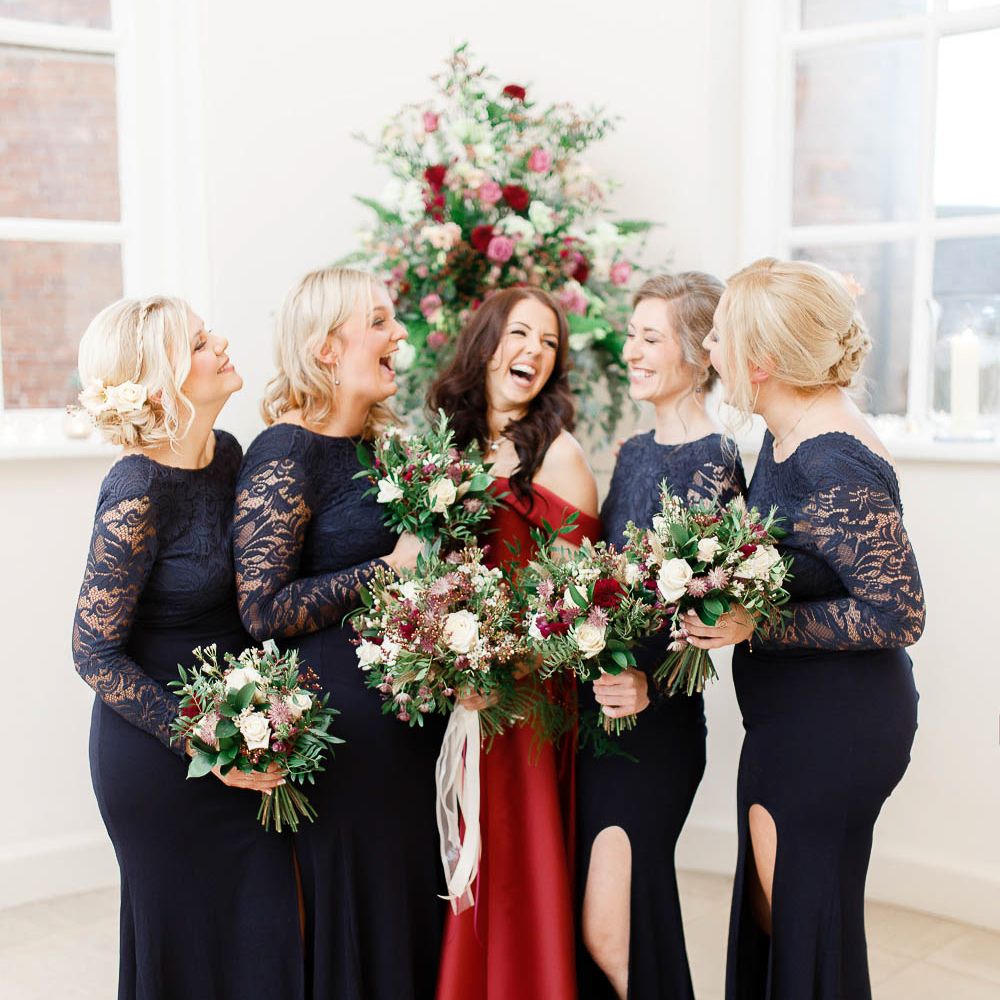 Bridal Party | Bridesmaids in Lace Navy Dresses | Bride in Bespoke Red Gown from agape Bridal Boutique | Red New Years Eve Winter Wedding at Iscoyd Park, Shropshire | White Stag Wedding Photography | Lovetwofilm