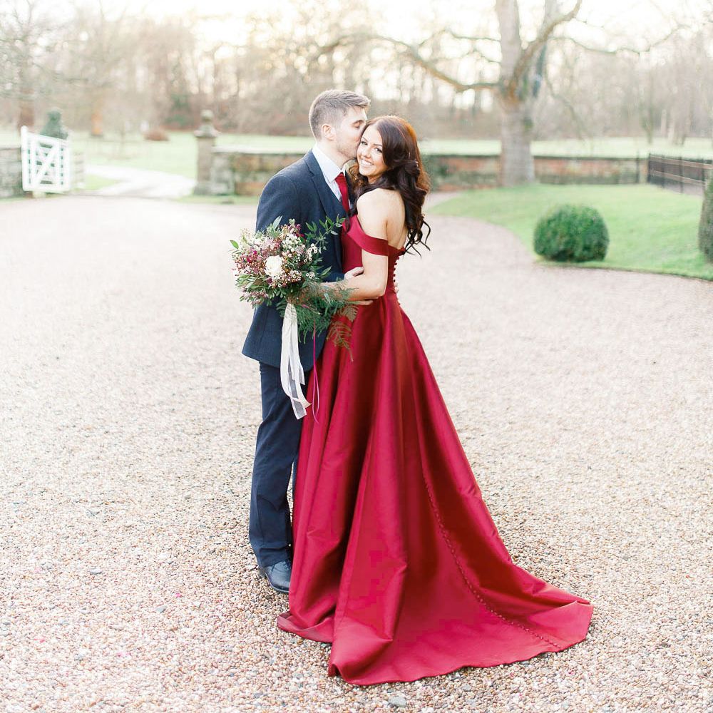 Bride in Bespoke Red Gown from agape Bridal Boutique | Groom in Slaters Suit | Red New Years Eve Winter Wedding at Iscoyd Park, Shropshire | White Stag Wedding Photography | Lovetwofilm