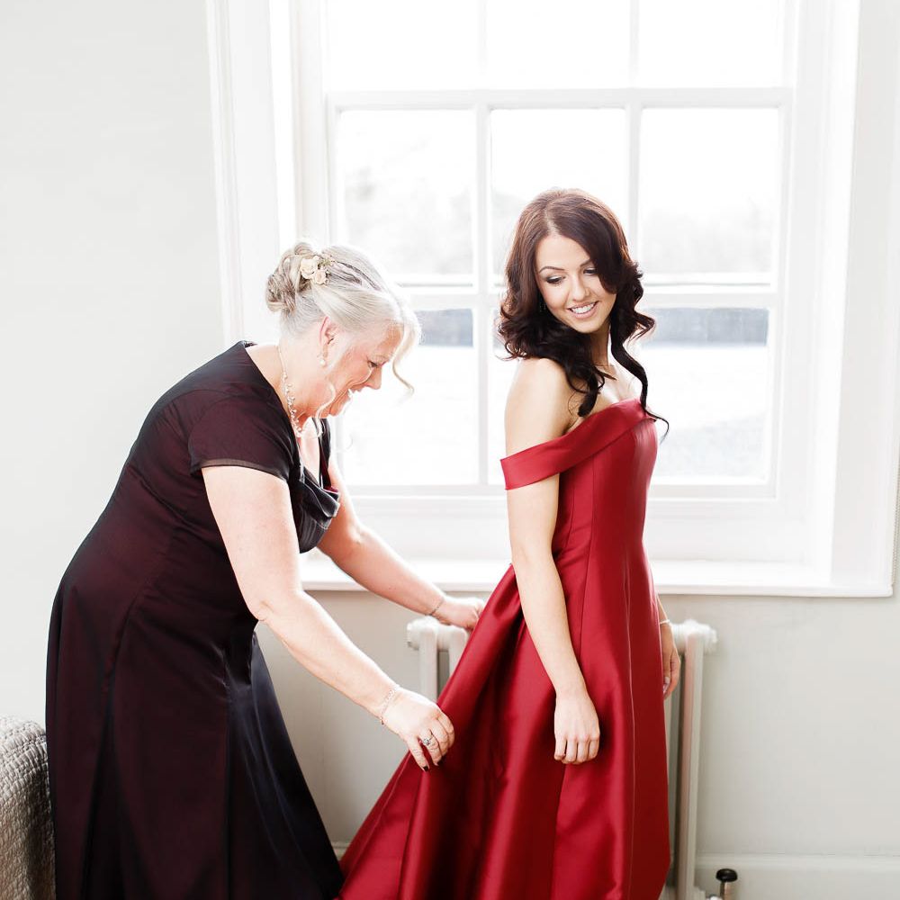 Wedding Morning Bridal Preparations | Bride in Bespoke Red Dress from Agape Bridal Boutique | Red New Years Eve Winter Wedding at Iscoyd Park, Shropshire | White Stag Wedding Photography | Lovetwofilm