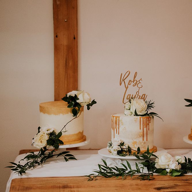 Separate wedding cakes with gold detail