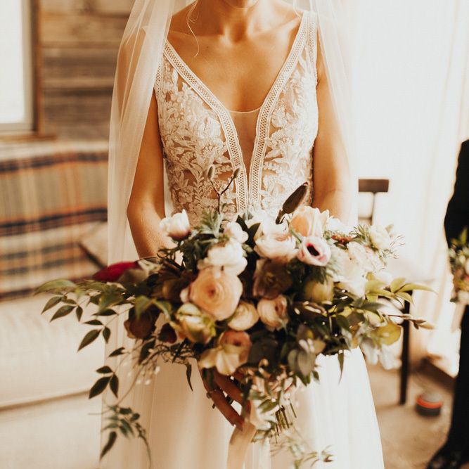 Lace detail wedding dress with veil and blush bouquet