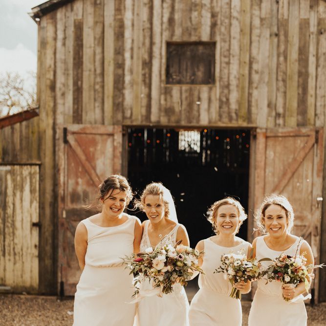 Bride with bridal party in blush bridesmaid dresses