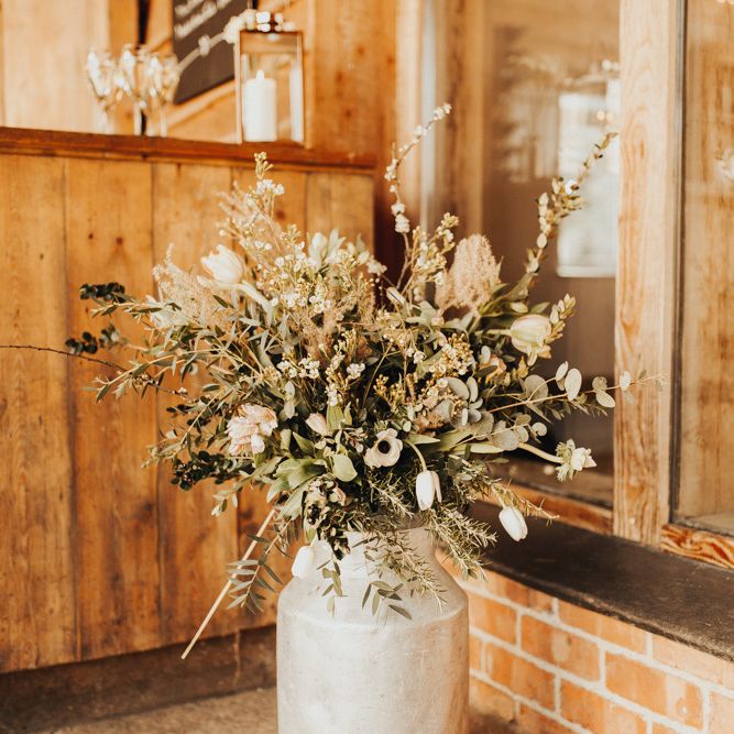 Wedding flowers in rustic milk churn