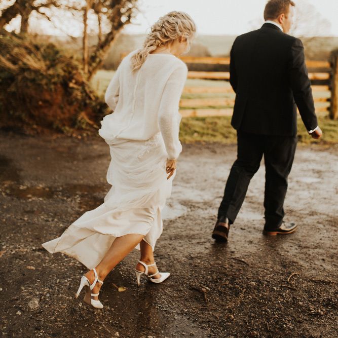 Bride with braided updo and bridal jumper