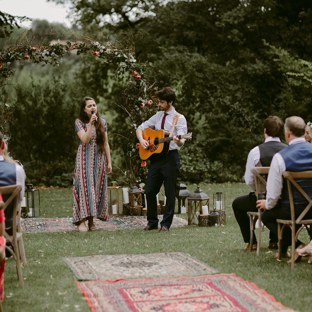 Wedding Ceremony | Persian Rug &amp; Floral Arch Wedding Decor | Outdoor Boho Wedding at Chateau le Tour, France | Adam and Grace Photography | Head and Heart Films