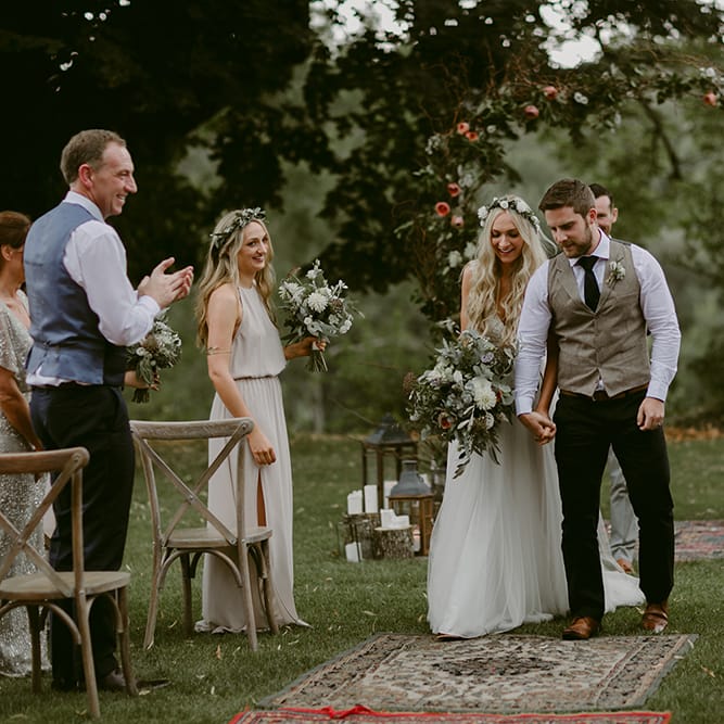 Outdoor Wedding Ceremony | Bride in Daalarna Gown | Groom in Waistcoat | Persian Rug, &amp; Floral Arch Aisle &amp; Altar Wedding Decor | Outdoor Boho Wedding at Chateau le Tour, France | Adam and Grace Photography | Head and Heart Films