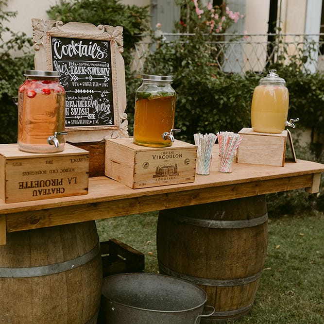Cocktail Station with Drinks Dispensers | Festoon Lit Outdoor Boho Wedding at Chateau le Tour, France | Adam and Grace Photography | Head and Heart Films