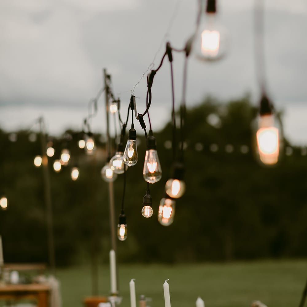 Edison Bulbs Wedding Lighting | Outdoor Boho Wedding at Chateau le Tour, France | Adam and Grace Photography | Head and Heart Films