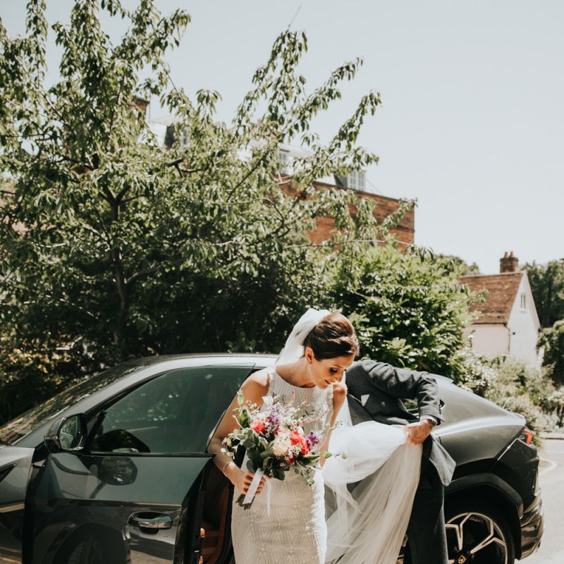 Bride in pink wedding shoes with bright bouquet