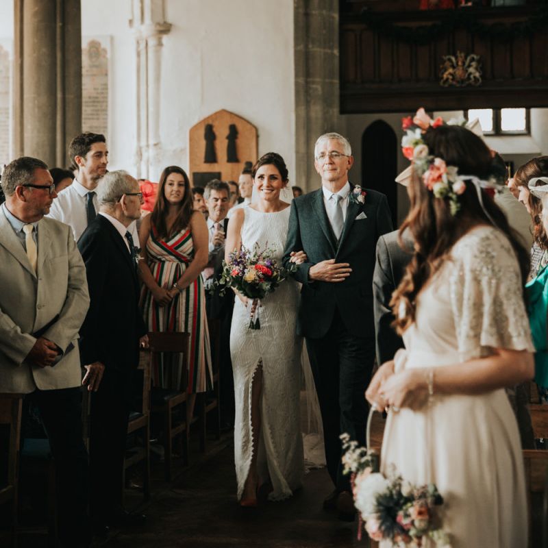 Bride walks down the aisle at church ceremony