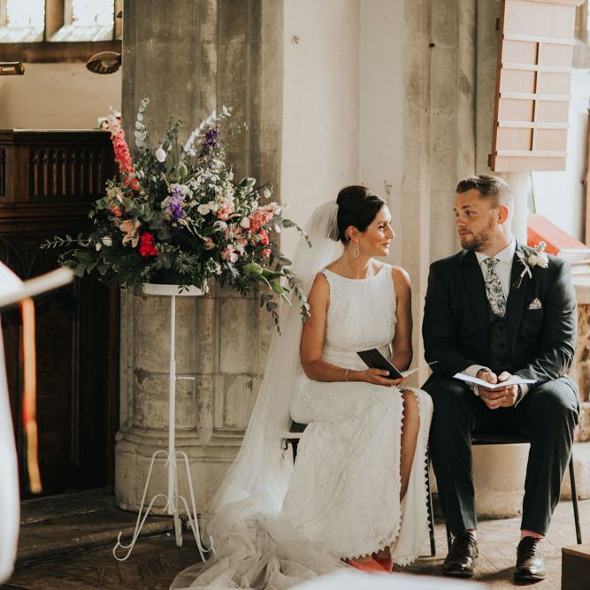 Bride and groom at church wedding with different bridesmaid dresses