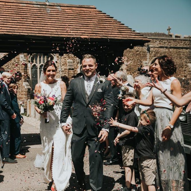 Confetti exit for bride and groom with different bridesmaid dresses