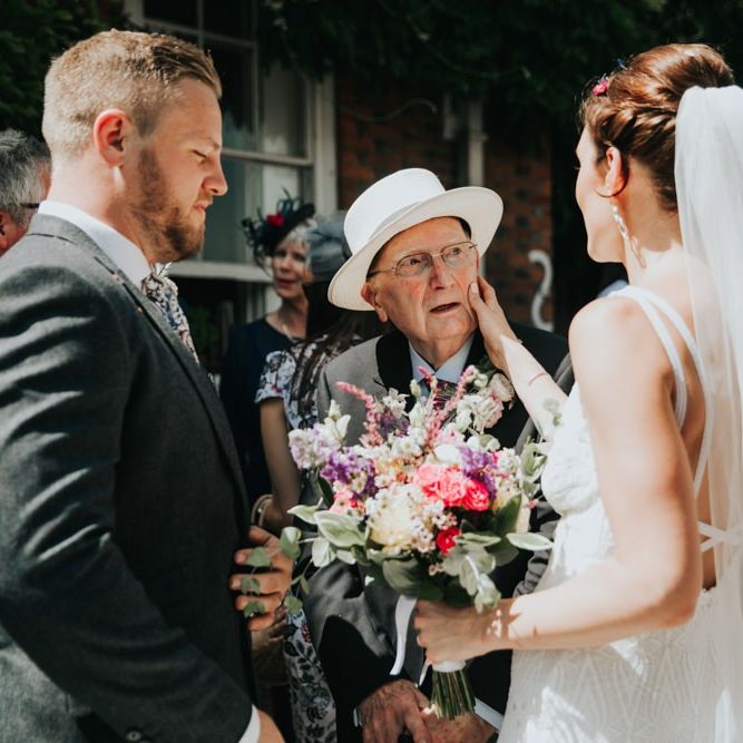 Bride and groom greet wedding guests