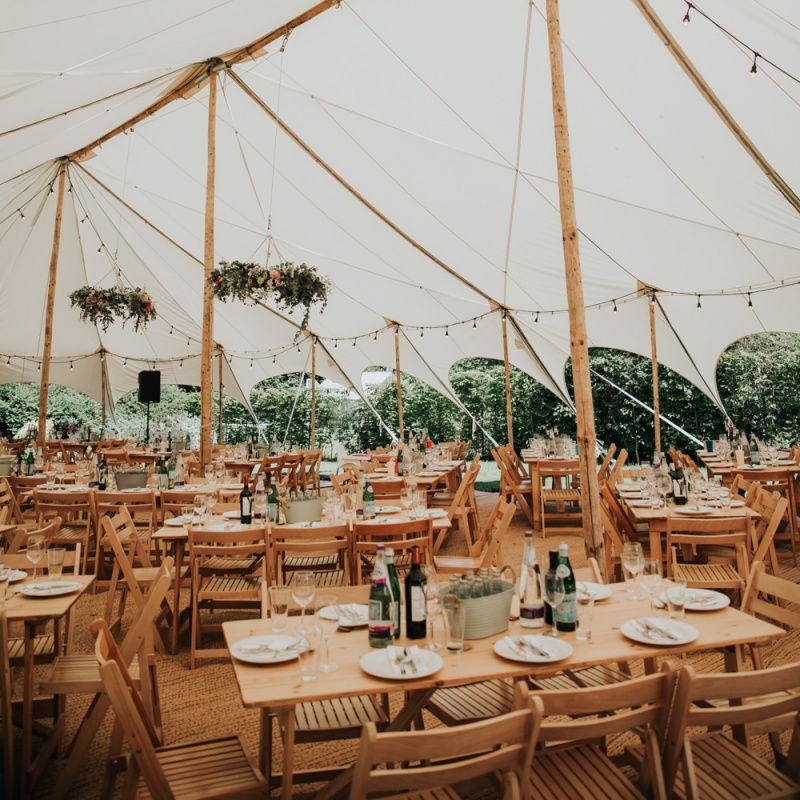 Marquee wedding in garden at home with different bridesmaid dresses
