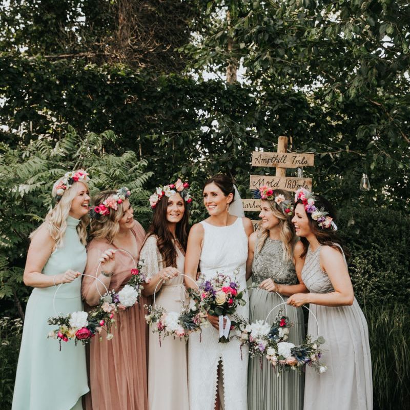 Bridal party in different bridesmaid dresses with hoop bouquets