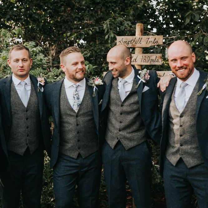 Groomsmen in matching three piece suits