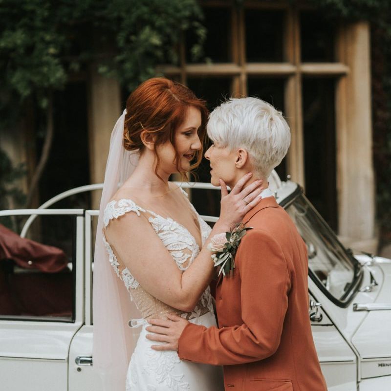 Bride with short hair in coloured wedding suit