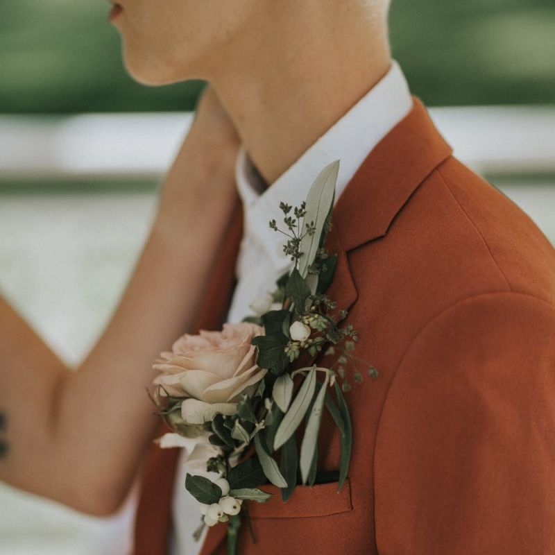 Rust wedding suit and pink buttonhole