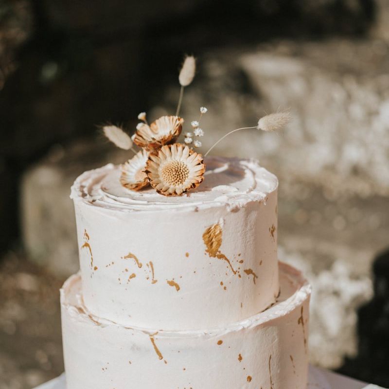 buttercream wedding cake with gold decor