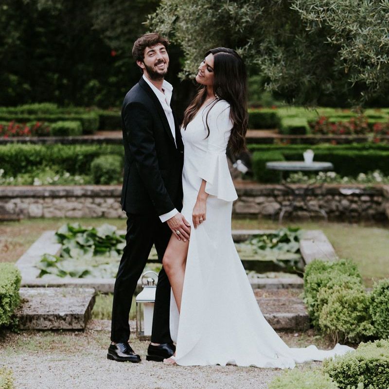 Bride in Pronovias wedding dress  with groom in black suit