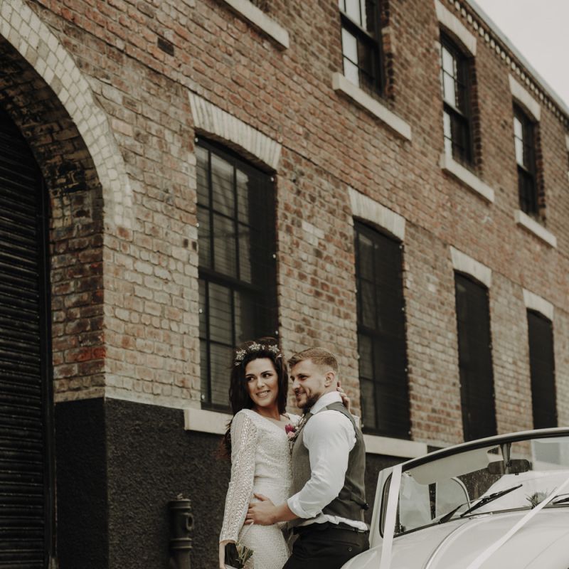 Bride and Groom Standing Next to VW Beetle Wedding Car