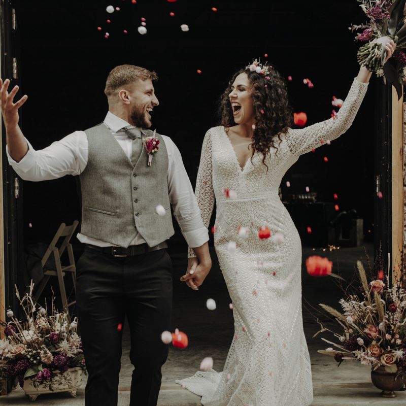 Confetti Moment with Bride in Lace Wedding Dress and Groom in Wool Waistcoat