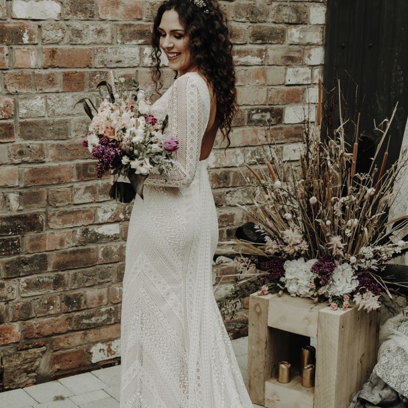 Boho Bride in Lace Wedding Dress Holding Dried Flower Bouquet