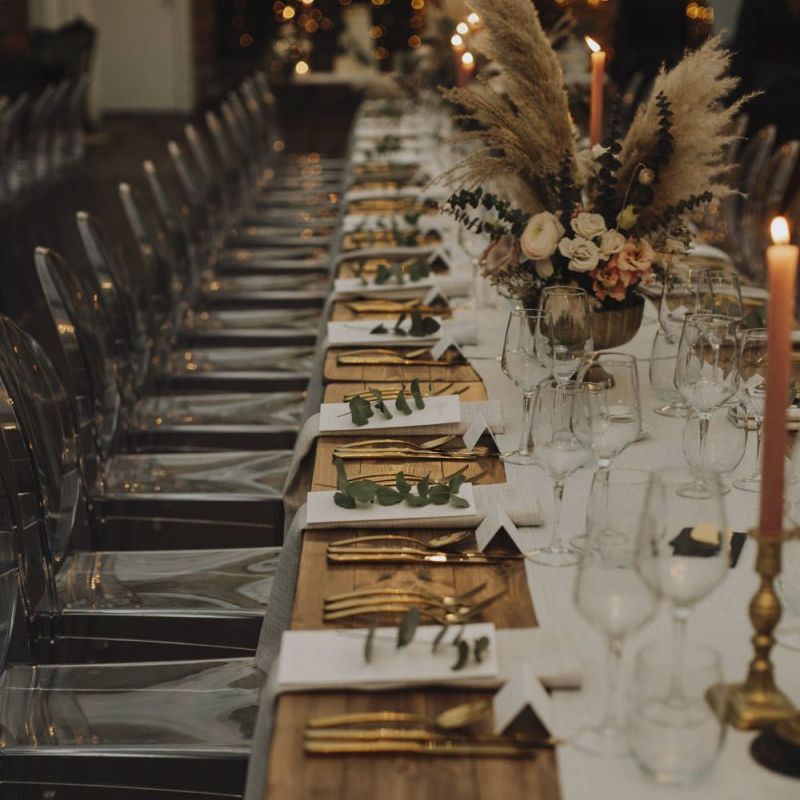Place Settings with Gold Cutlery and Ghost Chairs