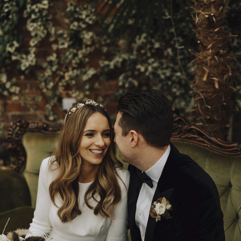 Bride in Emma Beaumont Wedding Dress and Groom in Tuxedo  Looking into Each Others Eyes
