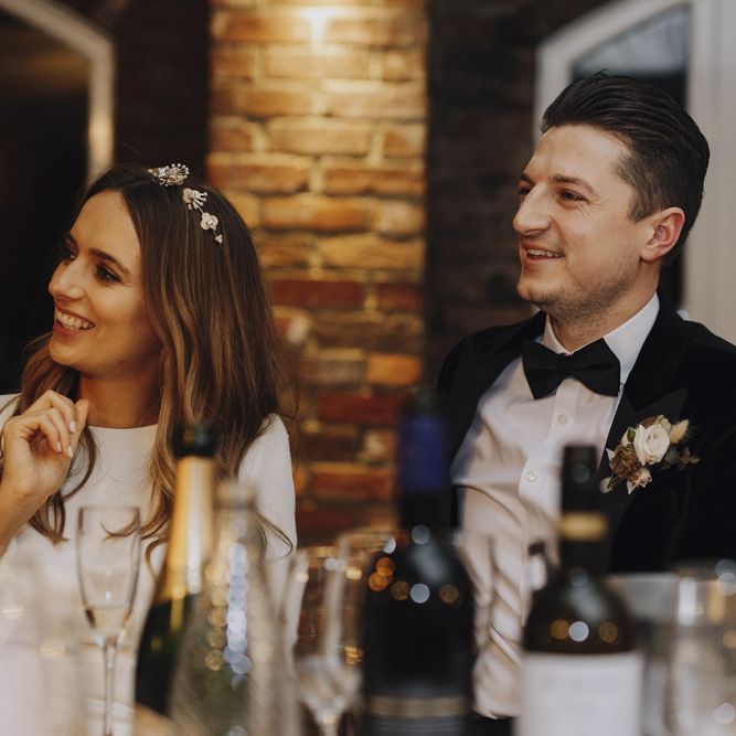 Bride and Groom Laughing During Wedding Reception Speeches