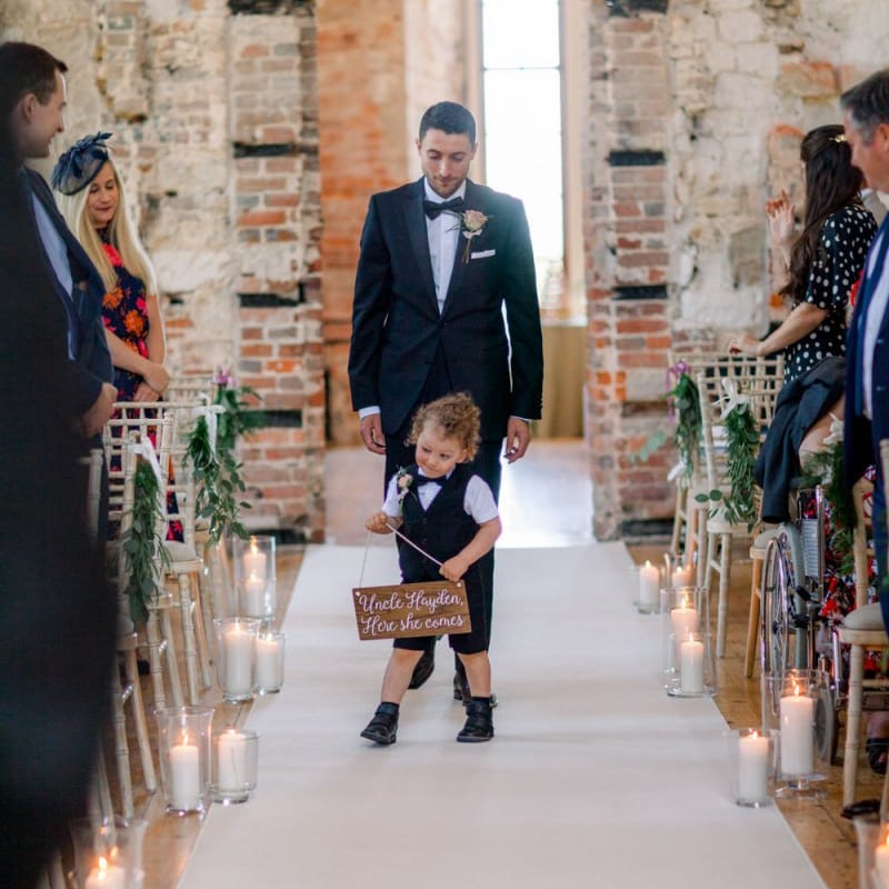 Cute page boy with wedding sign