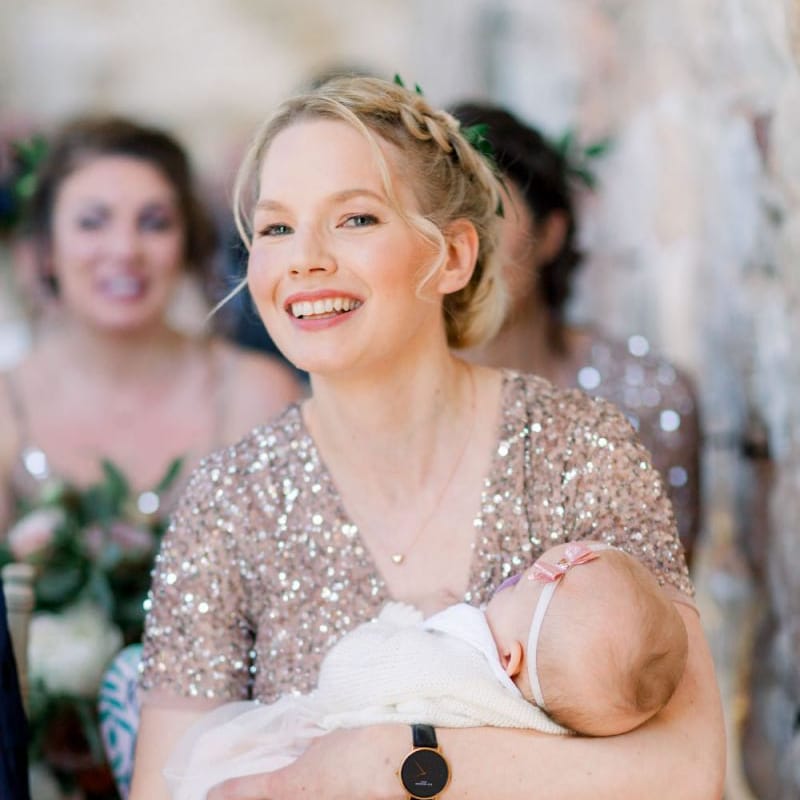 Beautiful bridesmaid with baby