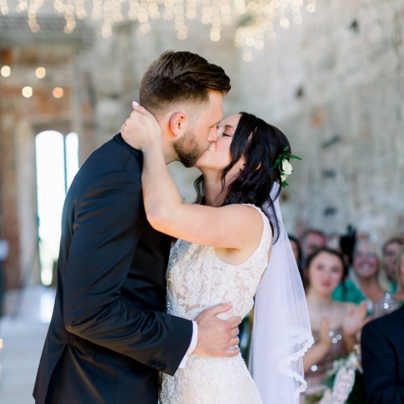 Bride and groom kiss at Lulworth Castle wedding