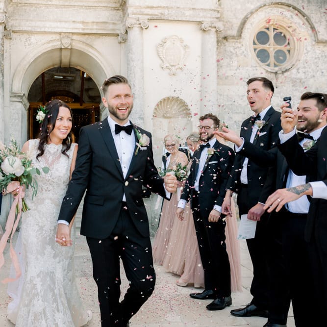Confetti exit for bride and groom at Lulworth Castle wedding