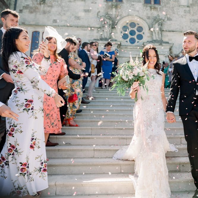 Confetti exit for bride and groom at Lulworth Castle wedding