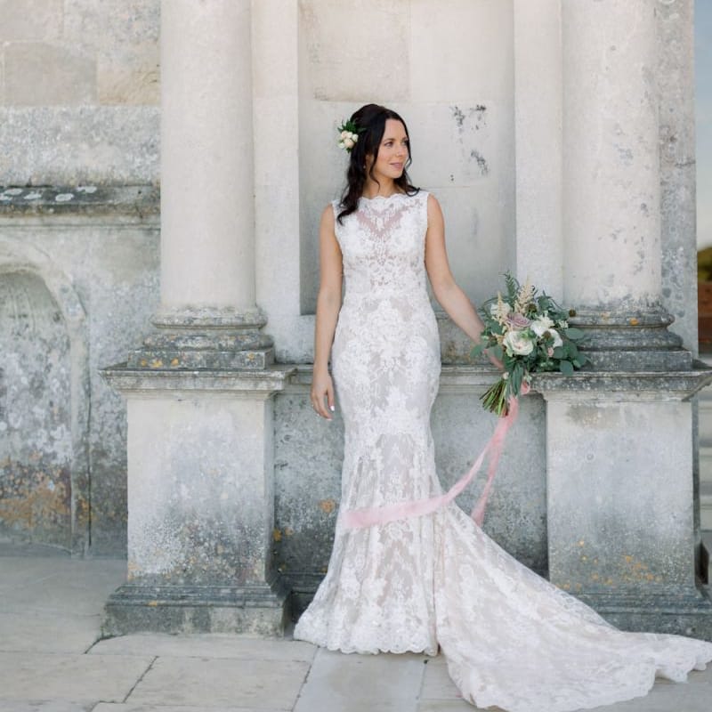 Beautiful bride in lace wedding dress with flower hairpiece