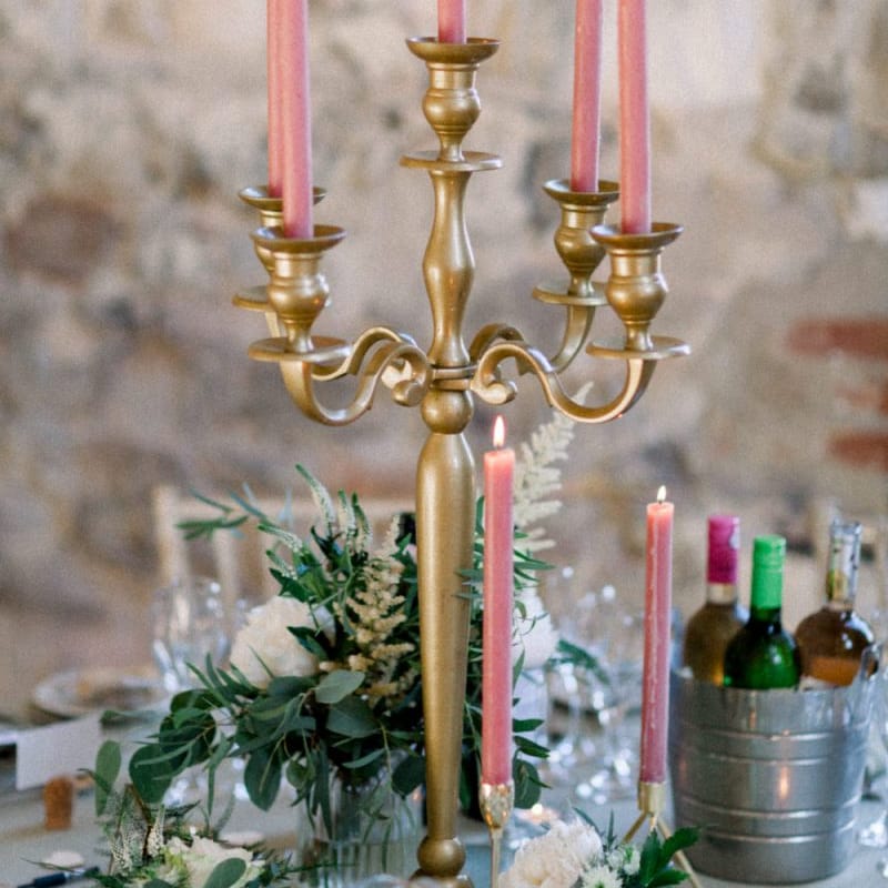 Pink candles in gold candelabra