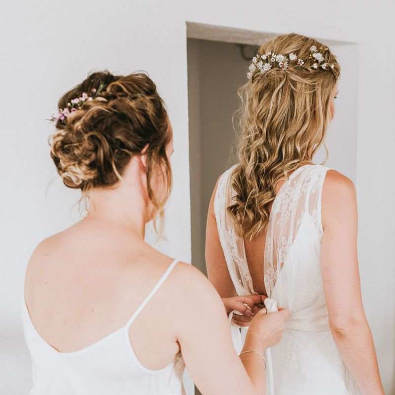 Bride gets into her wedding dress with half up half down hairstyle