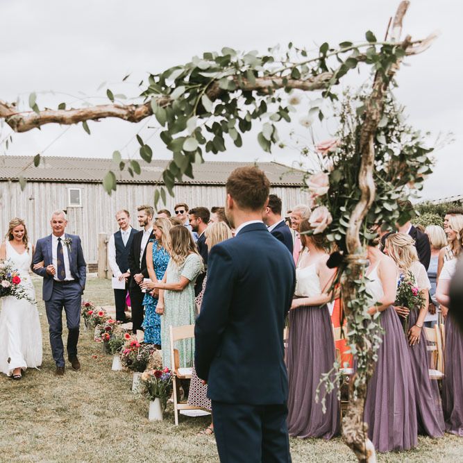 Wooden altar decor with foliage and flower decor for sustainable and vegan wedding