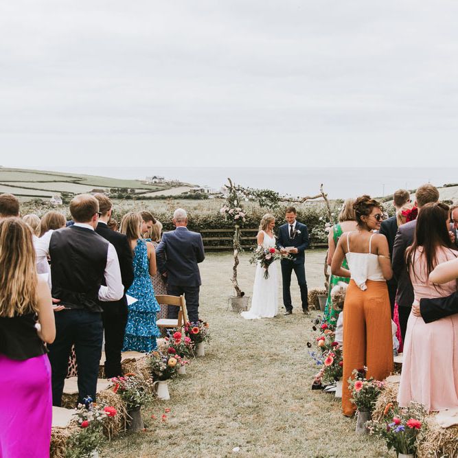 Bride and groom during outdoor ceremony at vegan wedding