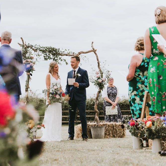 Bride and groom during outdoor ceremony at vegan wedding