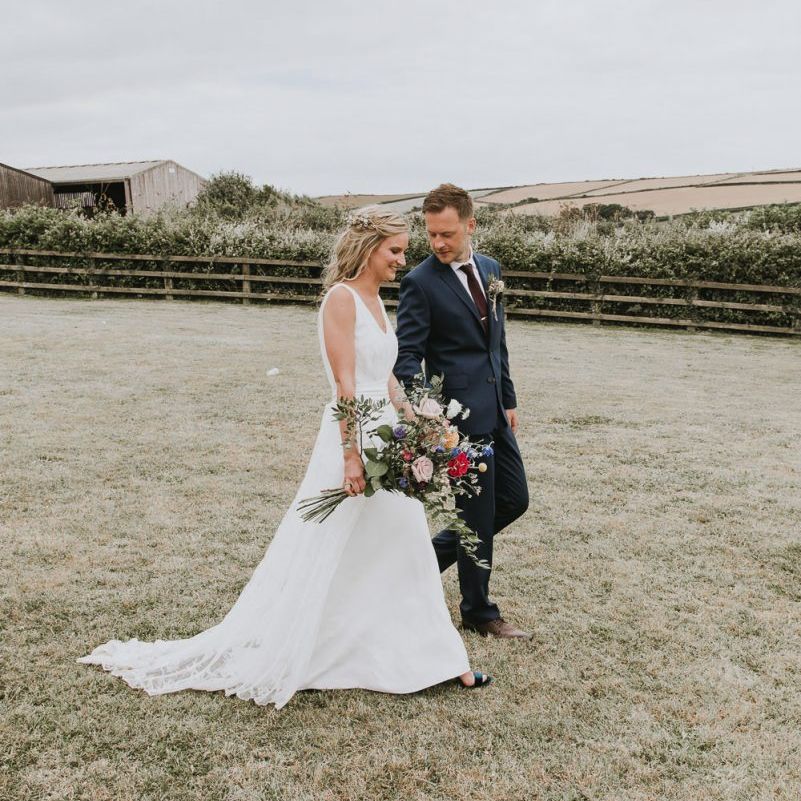 Bride and groom with wildflower bouquet at eco-friendly and vegan wedding
