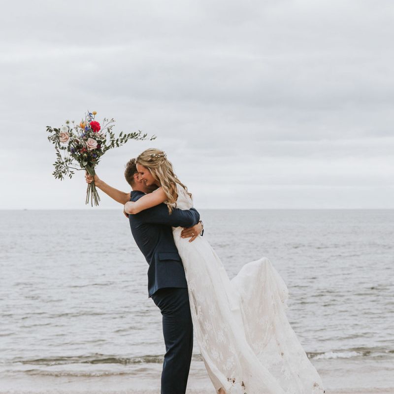 Coastal wedding in Devon with wildflower bouquet
