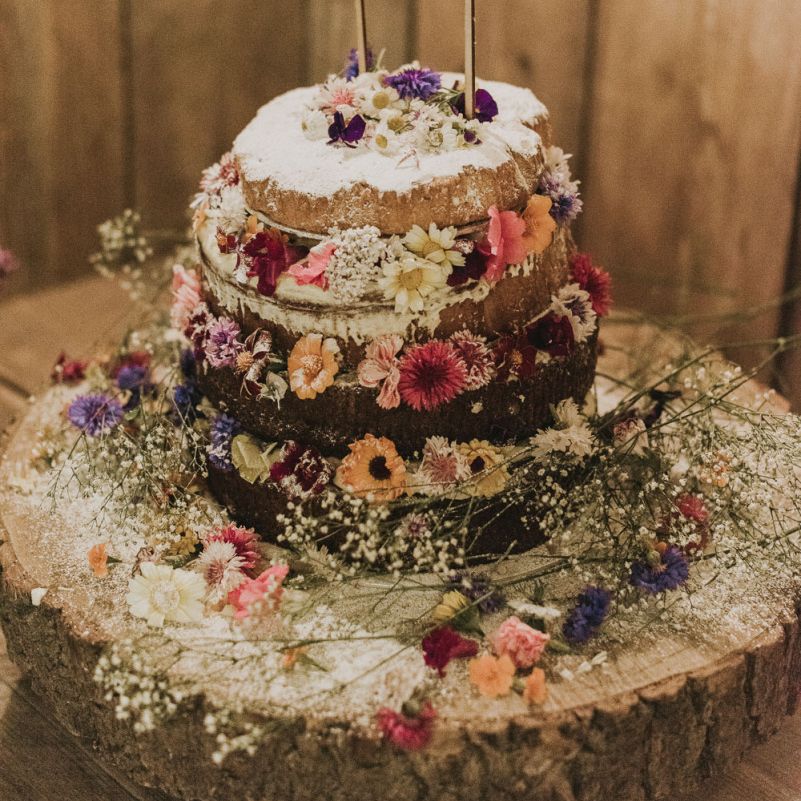 Homemade naked  wedding cake with flower decoration
