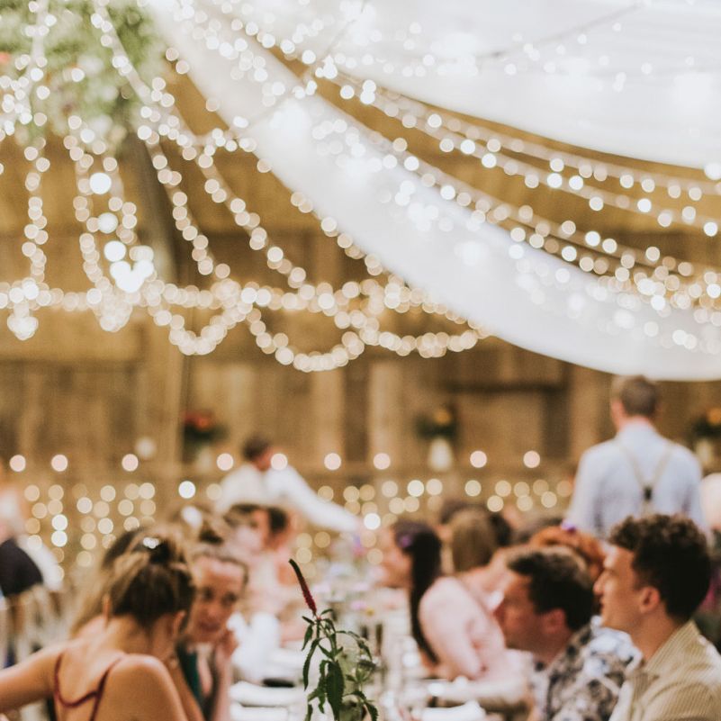 Fairy light canopy and drapes over vegan wedding breakfast
