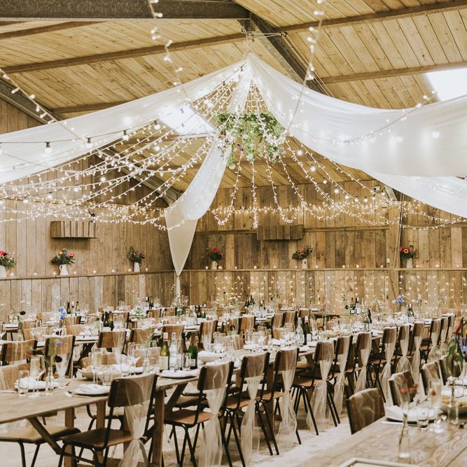 Fairy light canopy and drapes over vegan wedding breakfast