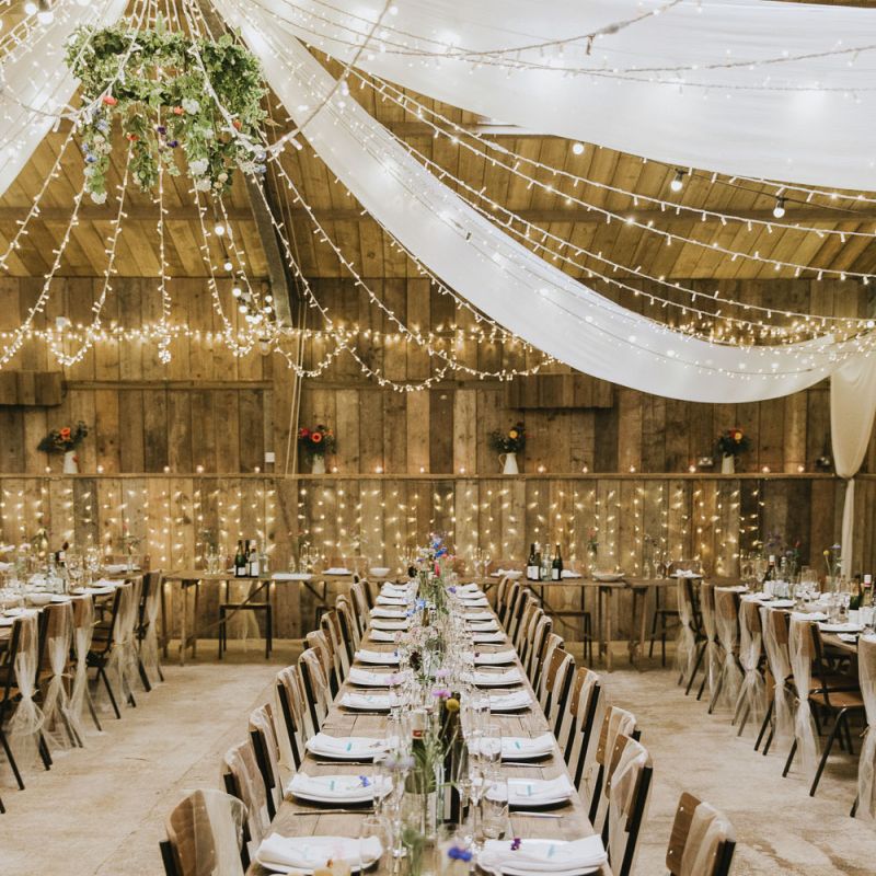 Fairy light canopy and drapes over vegan wedding breakfast