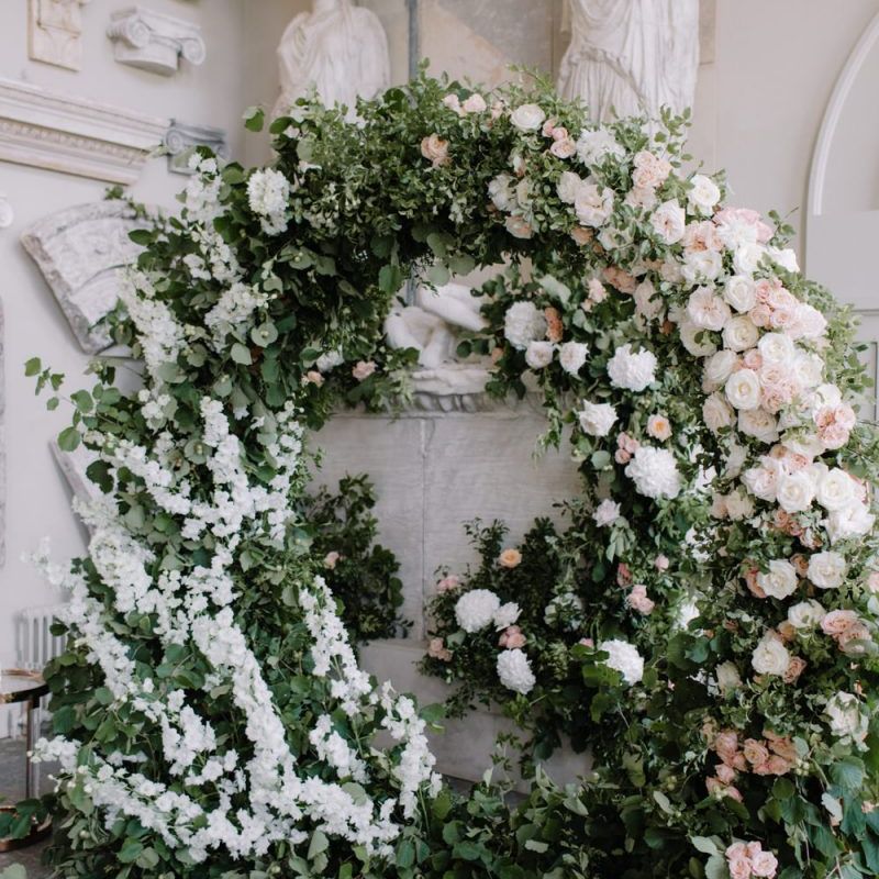 Green, white and pink floral moon gate at Aynhoe Park