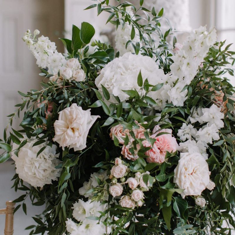 White and pink wedding flower arrangements with foliage